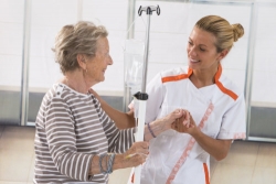 caregiver assisting elderly woman